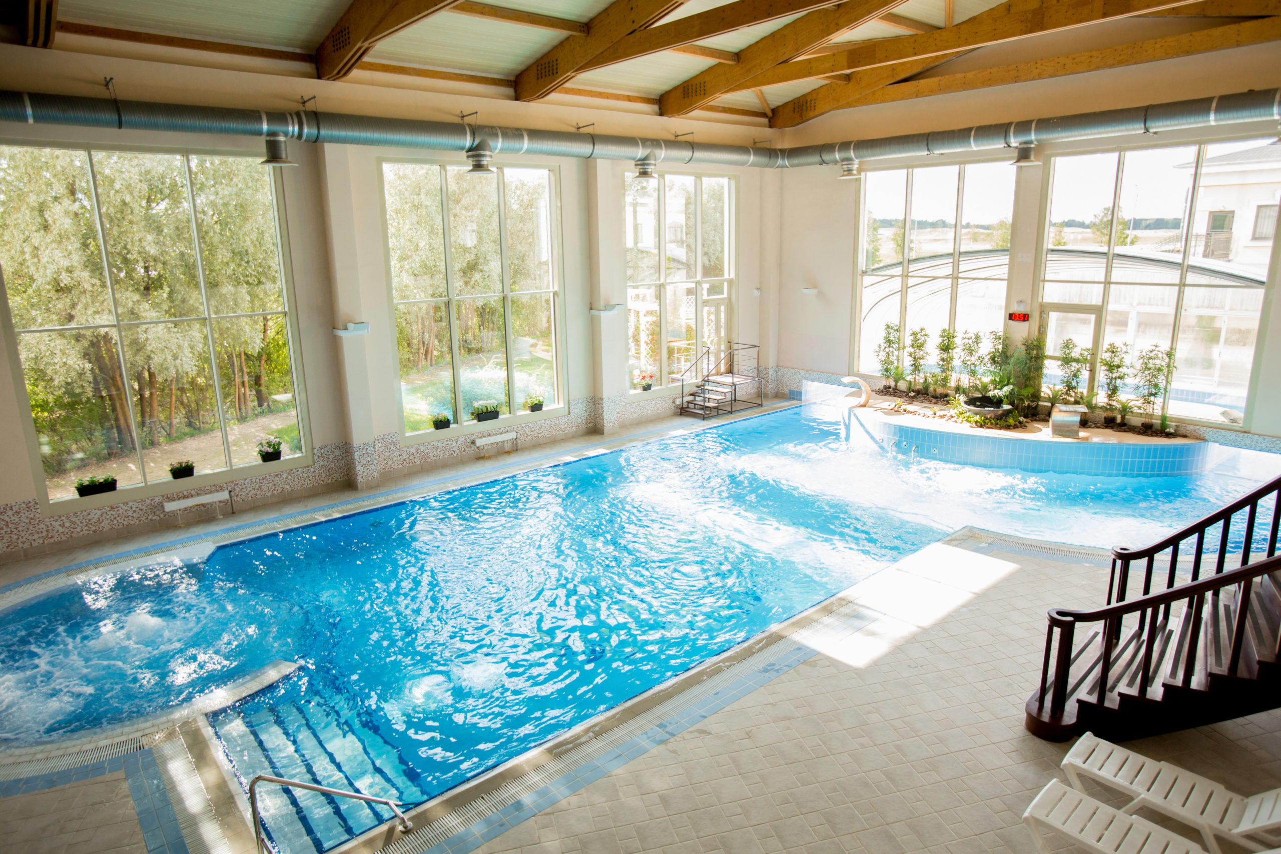 Spacious room with swimming-pool in its center at spa resort or hotel